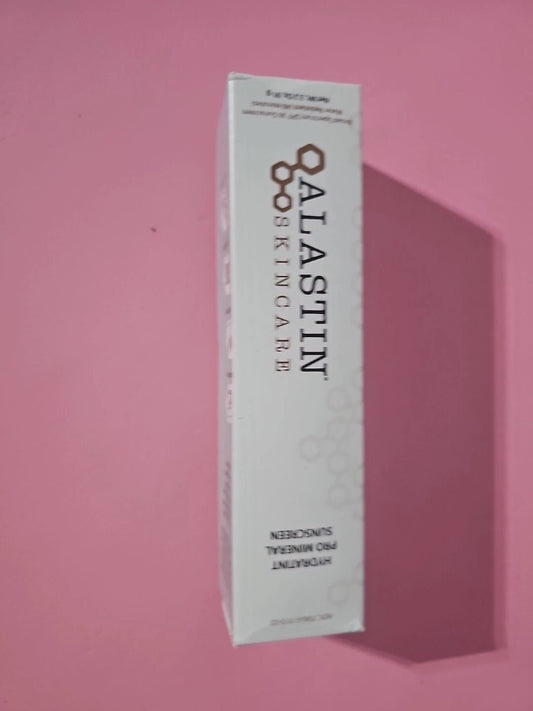 A white rectangular box of ALASTIN SKINCARE Hydrating Sunscreen, shown standing upright against a solid pink background with a soft shadow cast to the right.