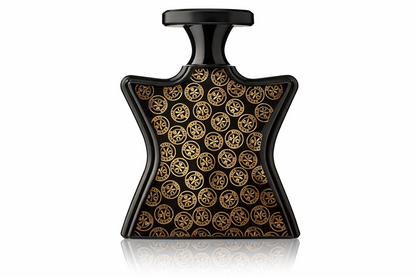 A bottle of Bond Street fragrance with a distinctive hourglass-shaped black body covered in a repeating gold circular logo pattern, topped with a black cap, shown on a white background with a soft reflection below.