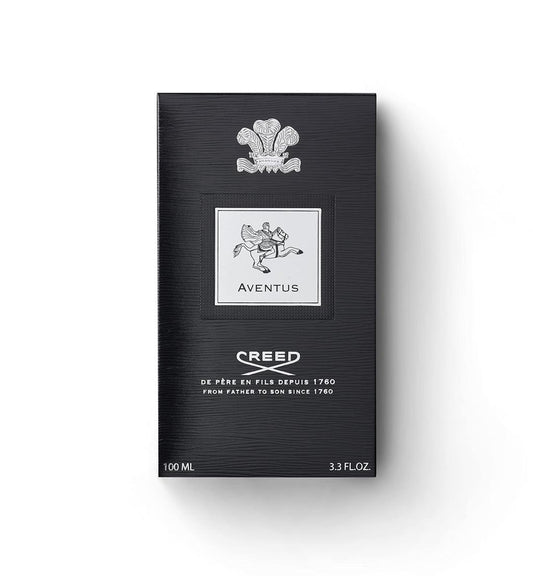Creed Aventus 100ml box packaging, featuring a textured black background with a silver crest and logo details, set against a plain white background.
