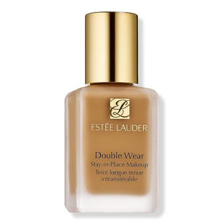 Estée Lauder Double Wear Stay-in-Place Makeup foundation bottle with a gold cap and a warm tan-brown liquid visible through the frosted glass, on a white background.