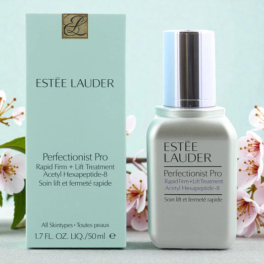 Estée Lauder Perfectionist Pro treatment bottle and packaging with cherry blossoms in the background.