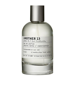 A 100ml bottle of ANOTHER 13 Eau de Parfum with a clear glass body, light-colored liquid, a white label with black text, and a metallic silver cap, shown on a plain white background.