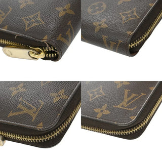 Close-up of a Louis Vuitton wallet with monogram pattern and gold zipper.